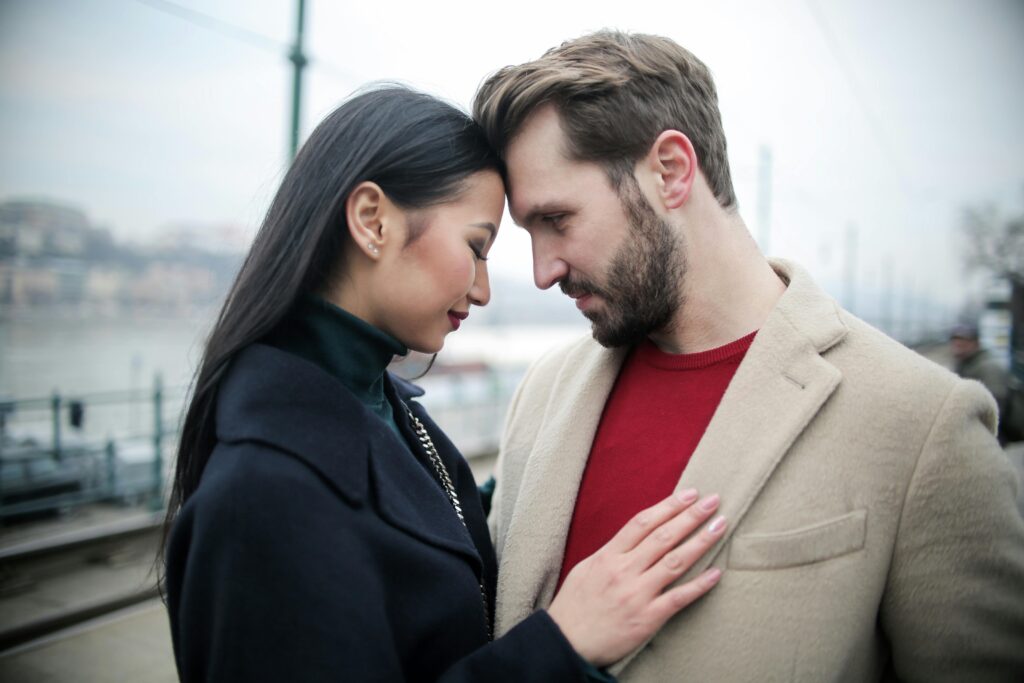 An asian woman and white man on a date outside. 