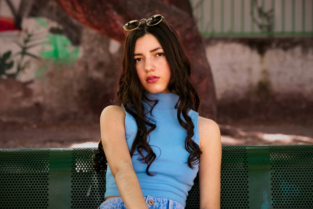 Brunette woman in blue sleeveless sweater