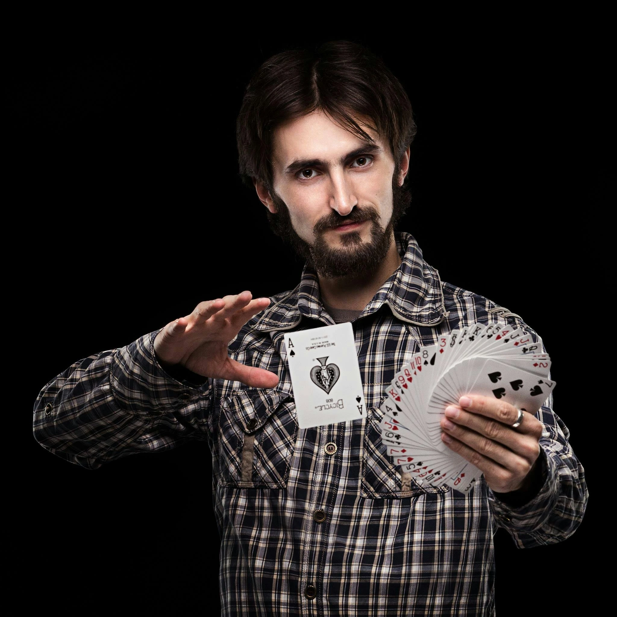 Man with a beard doing card tricks